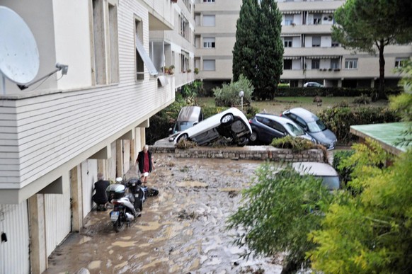 epa06195737 Cars that were taken with by floods sit in a ground floor in Livorno, Italy, 10 September 2017. According to reports, five people were found dead in a flooded basement after abundant rain. ...