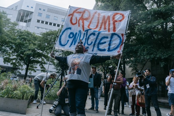 epaselect epa11380618 An Anti-Trump protester reacts outside the courthouse after former US President Donald Trump was found guilty during his criminal trial at New York State Supreme Court in New Yor ...
