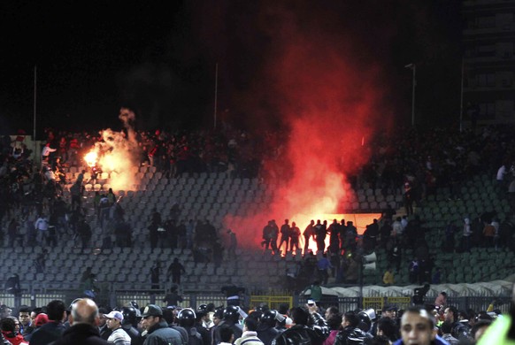 FILE - In this Feb. 1, 2012 file photo, Egyptian fans rush onto the field and clash in the stands following an Al-Ahly club soccer match against Al-Masry club at the soccer stadium in Port Said, Egypt ...