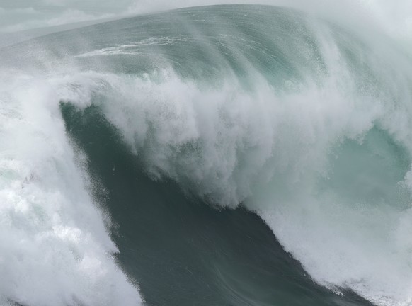 Surfer Eric Rebiere from France goes airborne exiting a wave during the Nazare Tow Challenge big wave surfing competition at Praia do Norte, or North Beach, in Nazare, Portugal, Thursday, Feb. 10, 202 ...