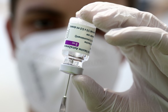 FILE - In this Monday, March 22, 2021 file photo, a member of the the medical staff prepares a syringe with the AstraZeneca coronavirus vaccine, during preparations at the vaccine center in Ebersberg  ...