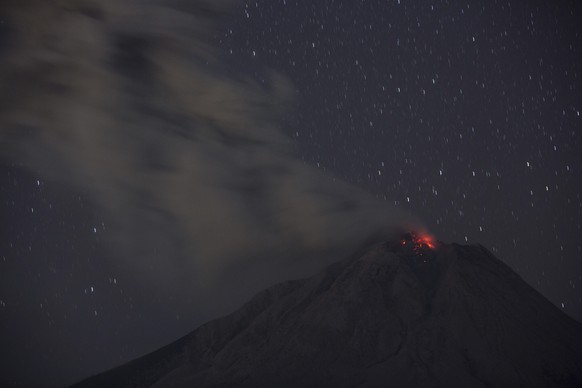 Mount Sinabung spews volcanic material during an eruption in this photo taken using slow shutter speed in Karo, North Sumatra, Indonesia, late Wednesday, March 10, 2021. The 2,600-metre (8,530-feet) v ...