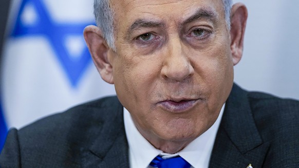 FILE - Israeli Prime Minister Benjamin Netanyahu chairs a cabinet meeting at the Kirya military base, which houses the Israeli Ministry of Defense, in Tel Aviv, Israel, on Dec. 24, 2023. Israeli offic ...