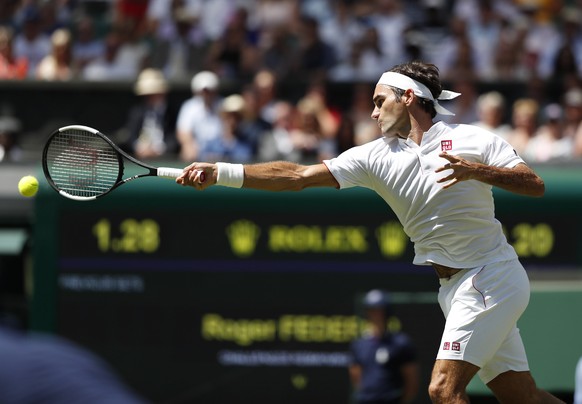 epa06857779 Roger Federer of Switzerland returns to Dusan Lajovic of Serbia in their first round match during the Wimbledon Championships at the All England Lawn Tennis Club, in London, Britain, 02 Ju ...