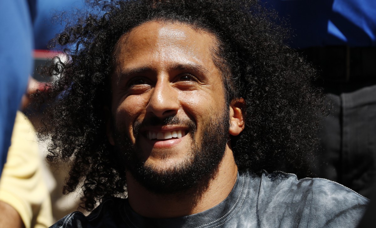 epa07802259 Former NFL quarterback Colin Kaepernick watches as Naomi Osaka of Japan plays Magda Linette of Poland during their match on the fourth day of the US Open Tennis Championships the USTA Nati ...