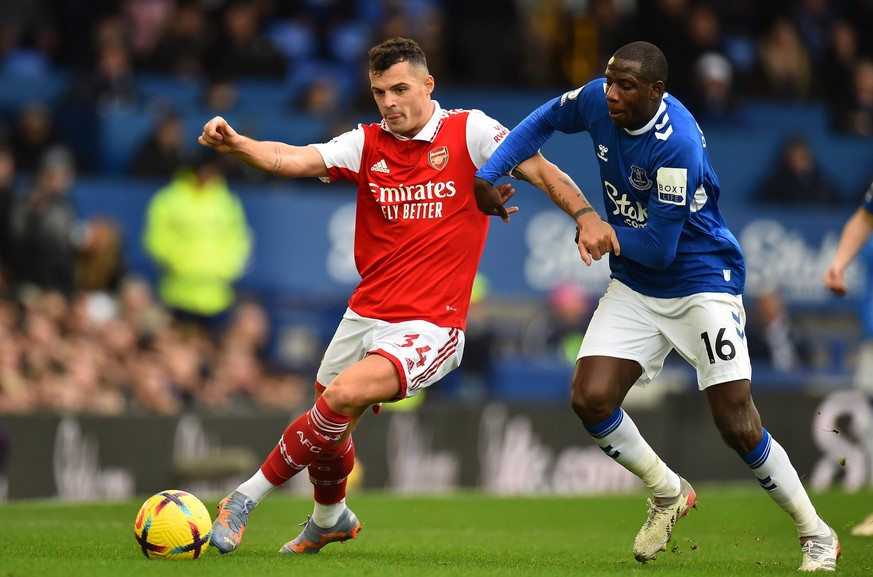 epa10446835 Arsenal&#039;s Granit Xhaka (L) in action against Everton&#039;s Abdoulaye Doucoure (R) during the English Premier League soccer match between Everton FC and Arsenal London in Liverpool, B ...