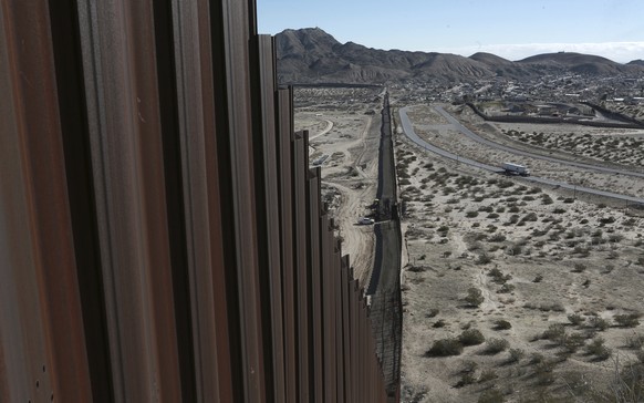 FILE - In this Wednesday, Jan. 25, 2017 file photo, a truck drives near the Mexico-US border fence, on the Mexican side, separating the towns of Anapra, Mexico and Sunland Park, New Mexico. A third of ...