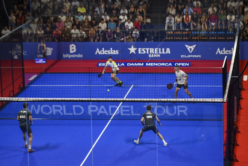 epa10258848 Jon Sanz, in team with Lucas Campagnolo (below), face to Ramiro Moyano and Francisco Gil (top) during an Estrella Damn Menorca Open semifinal game, in Menorca, Spain, on 22 October 2022. E ...