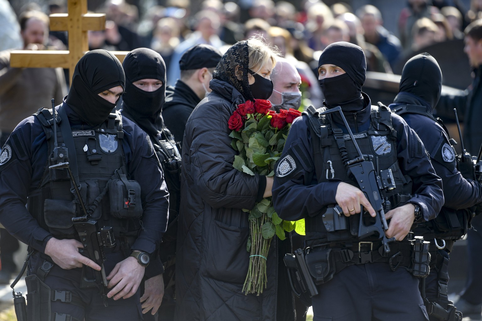 Armed Russian policemen guard an area during a funeral ceremony of slain Russian military blogger Vladlen Tatarsky, at the Troyekurovskoye cemetery in Moscow, Russia, Saturday, April 8, 2023. Tatarsky ...