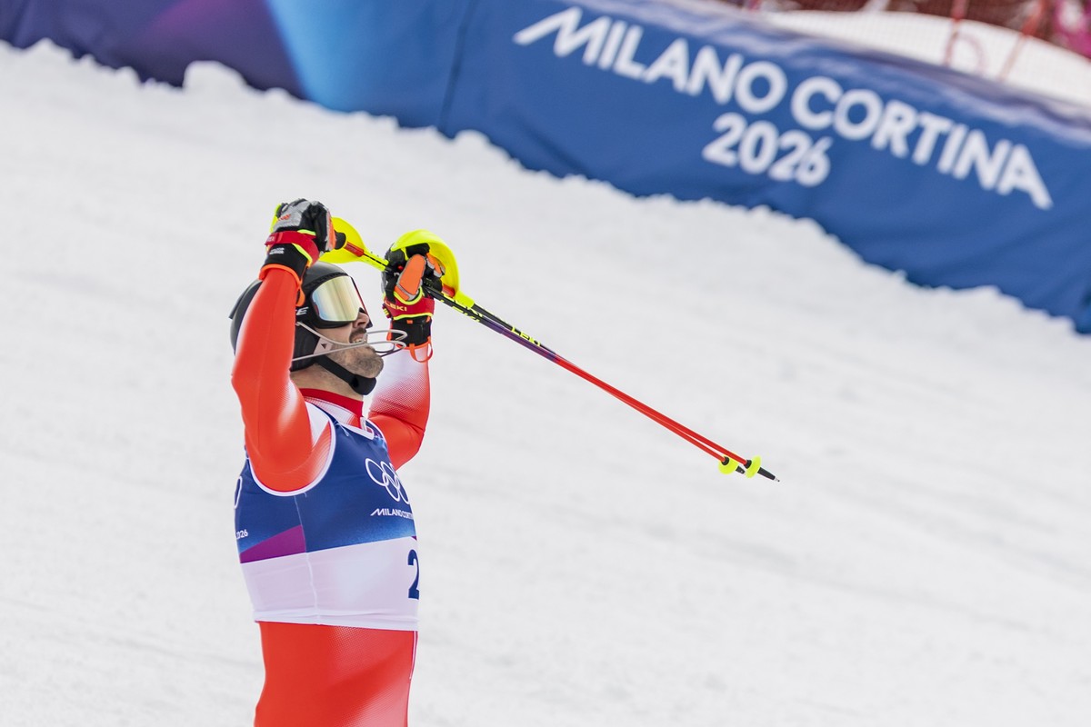 epa12746806 Winner Loic Meillard of Switzerland celebrates in the finish area during the Men's Alpine Skiing second run of the slalom race at the 2026 Olympic Winter Games at the Stelvio Ski Cent ...