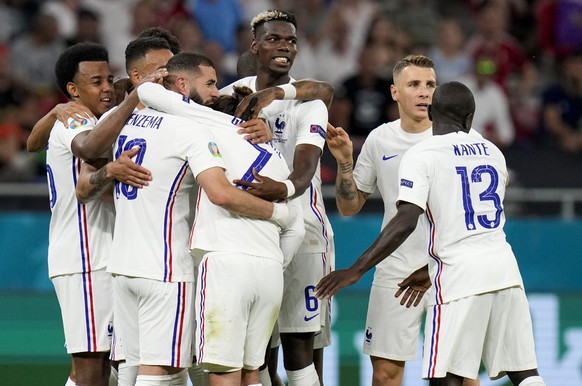 France&#039;s Karim Benzema, third left, is congratulated by teammates after scoring his team&#039;s second goal during the Euro 2020 soccer championship group F match between Portugal and France at t ...