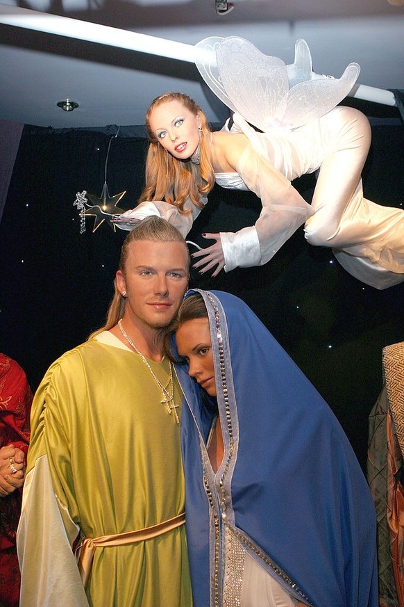 David Beckham and Victoria Beckham as Joseph and Mary and Kylie Mnogue as the Angel Are the celebrity Nativity at the Tussaud Wax Musem, London. 7/12/2004 (Photo by Goffredo di Crollalanza/FilmMagic)