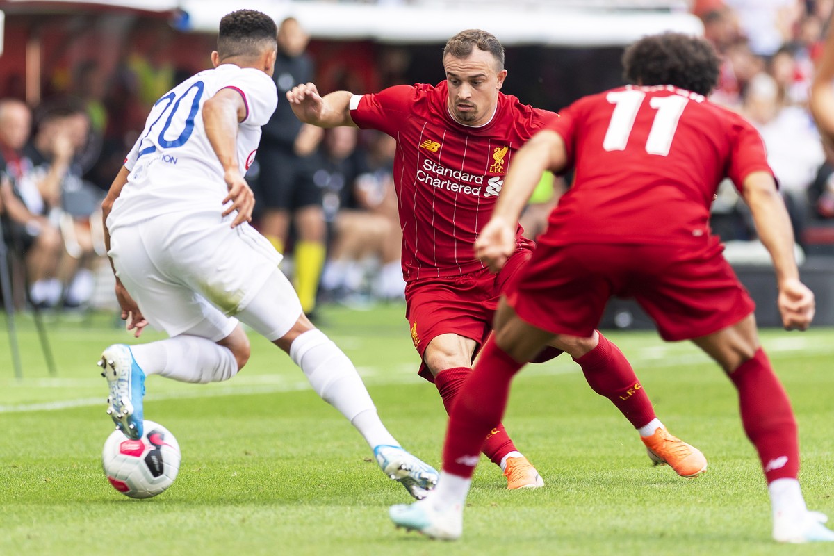 epa07750268 Liverpool's Xherdan Shaqiri (C) in action against Lyon's Fernando Marcal (L) during a friendly soccer match between Liverpool FC and Olympique Lyon in Geneva, Switzerland, 31 Jul ...