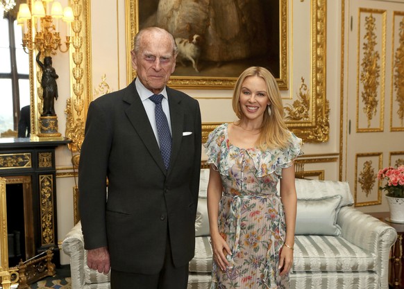 Britain&#039;s Prince Philip, the Duke of Edinburgh, Patron of the Britain-Australia Society, presents Kylie Minogue with the Britain-Australia Society Award for 2016 during a private audience in the  ...