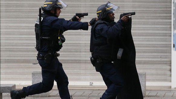 FILE - In this Nov. 18, 2015 file photo armed police operate in Saint-Denis, a northern suburb of Paris, Wednesday, Nov. 18, 2015. (AP Photo/Francois Mori)