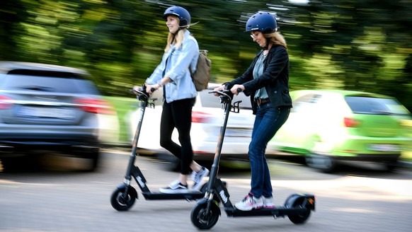 epa07627037 Women ride an CIRC e-scooter (former FLASH) in Herne, Germany, 05 June 2019. Even before electric pedal-scooters are allowed nationwide on 15 June, a first provider will start a rental ser ...