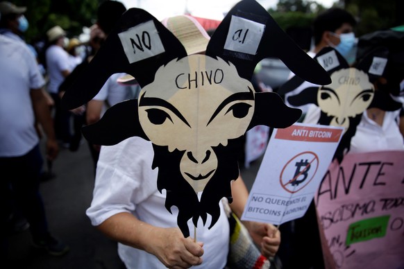 epa09470571 A person holds a poster in the shape of a goat, during a day of protests against the Government, in San Salvador, El Salvador, 15 September 2021. Thousands of Salvadorans protested in the  ...