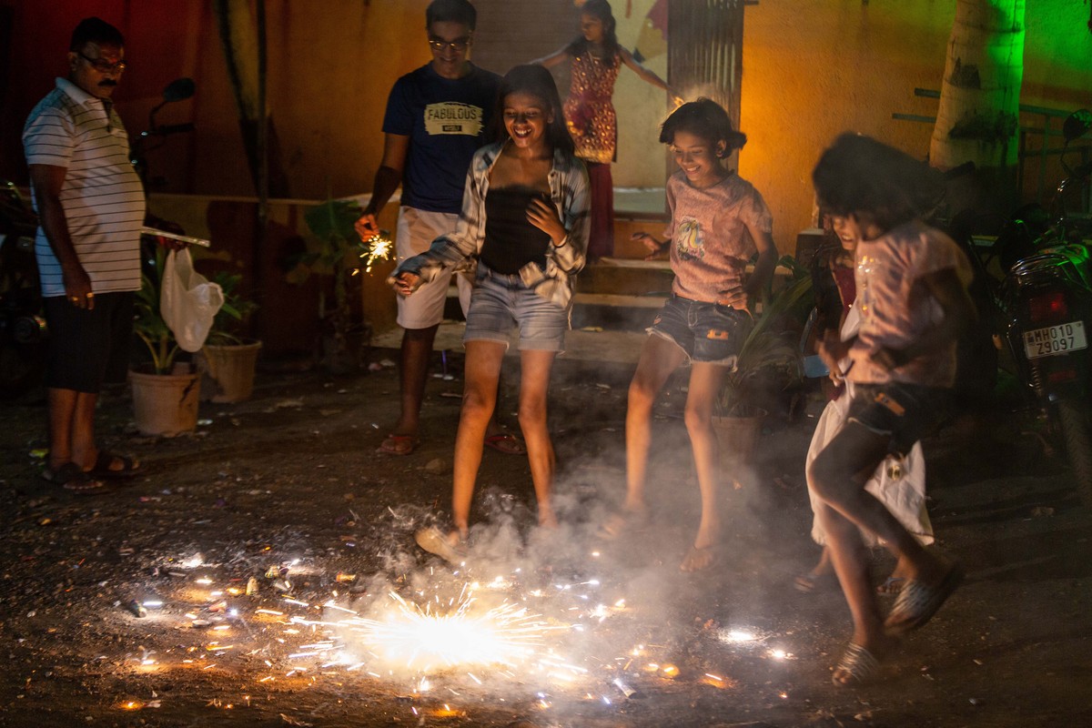 epa10263649 People burn fire crackers during the Diwali festival in Mumbai, India, 24 October 2022. During Diwali, celebrating Kali, the Hindu Goddess of Ultimate Power, the entire house is cleaned an ...