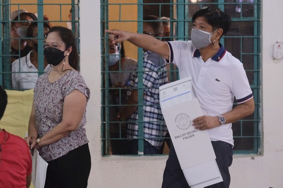Presidential candidate Ferdinand Marcos Jr., the son of the late dictator, votes at a polling center in Batac City, Ilocos Norte, northern Philippines on Monday, May 9, 2022. Filipinos were voting for ...