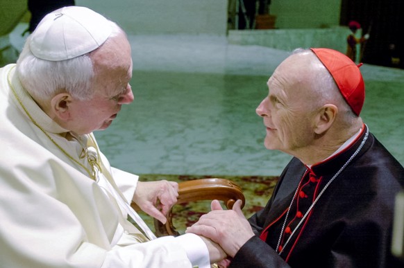 FILE - In this Feb. 23, 2001 file photo, U.S. Cardinal Theodore Edgar McCarrick, archbishop of Washington, D.C., shakes hands with Pope John Paul II during the General Audience with the newly appointe ...