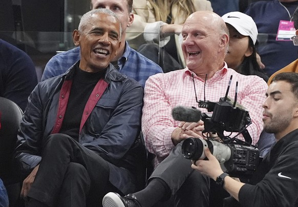 Former President Barack Obama, left, sits with Los Angeles Clippers owner Steve Ballmer during the first half of an NBA basketball game between the Clippers and the Detroit Pistons, Wednesday, March 5 ...