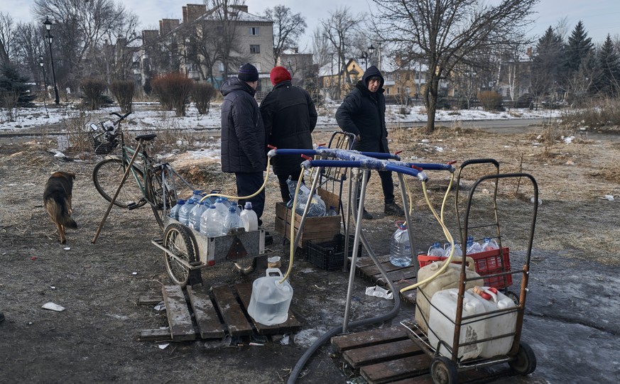 FILE - Local residents are given water in Bakhmut, Donetsk region, Ukraine, Friday, February 10, 2023. The relentless Russian bombardment has reduced Bakhmut to a smoldering wasteland with few buildings still standing…