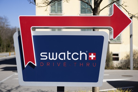 A sign shows the way to the Swatch drive through shop, photographed after a press conference to present Swatch&#039;s annual results for 2024, Wednesday, March 19, 2025, in Biel, Switzerland. (KEYSTON ...