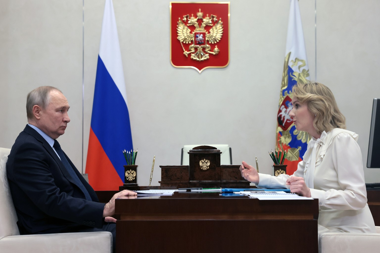 FILE - Russian President Vladimir Putin, left, listens to Russian Presidential Commissioner for Children&#039;s Rights Maria Lvova-Belova during their meeting at the Novo-Ogaryovo state residence, out ...