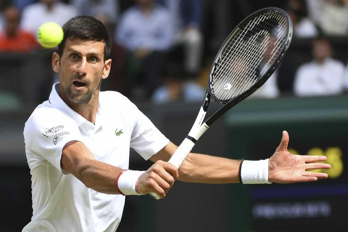 Serbia's Novak Djokovic returns to Spain's Roberto Bautista Agut in a Men's singles semifinal match on day eleven of the Wimbledon Tennis Championships in London, Friday, July 12, 2019. ...