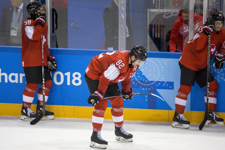 Eric Blum of Switzerland, Simon Moser of Switzerland, and Ramon Untersander of Switzerland, from left, react after the men ice hockey play-off qualification match between Switzerland and Germany in th ...