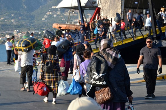 epa07812036 Refugees and migrants get on board &#039;Caldera Vista&#039; at the port of Mytilene, Greece, 02 September 2019. The transfer of 1,500 refugees and migrants from Mytilene began early in th ...