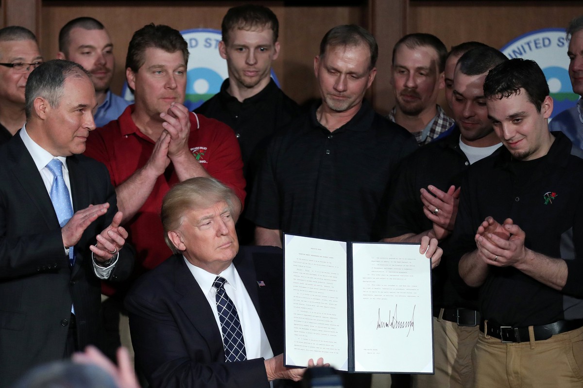 U.S. President Donald Trump holds up an executive order on "Energy Independence," eliminating Obama-era climate change regulations, during a signing ceremony at the Environmental Protection  ...