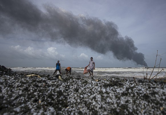 Sri Lankans salvage wreck washed off to the shore from the burning Singaporean ship MV X-Press Pearl which is anchored off Colombo port at Kapungoda, out skirts of Colombo, Sri Lanka, Wednesday, May 2 ...