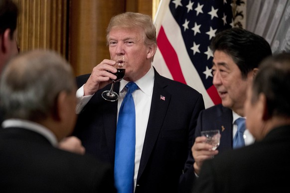 U.S. President Donald Trump and Japanese Prime Minister Shinzo Abe, right, share a drink after toasting each other during a state banquet at the Akasaka Palace, Monday, Nov. 6, 2017, in Tokyo. Trump i ...