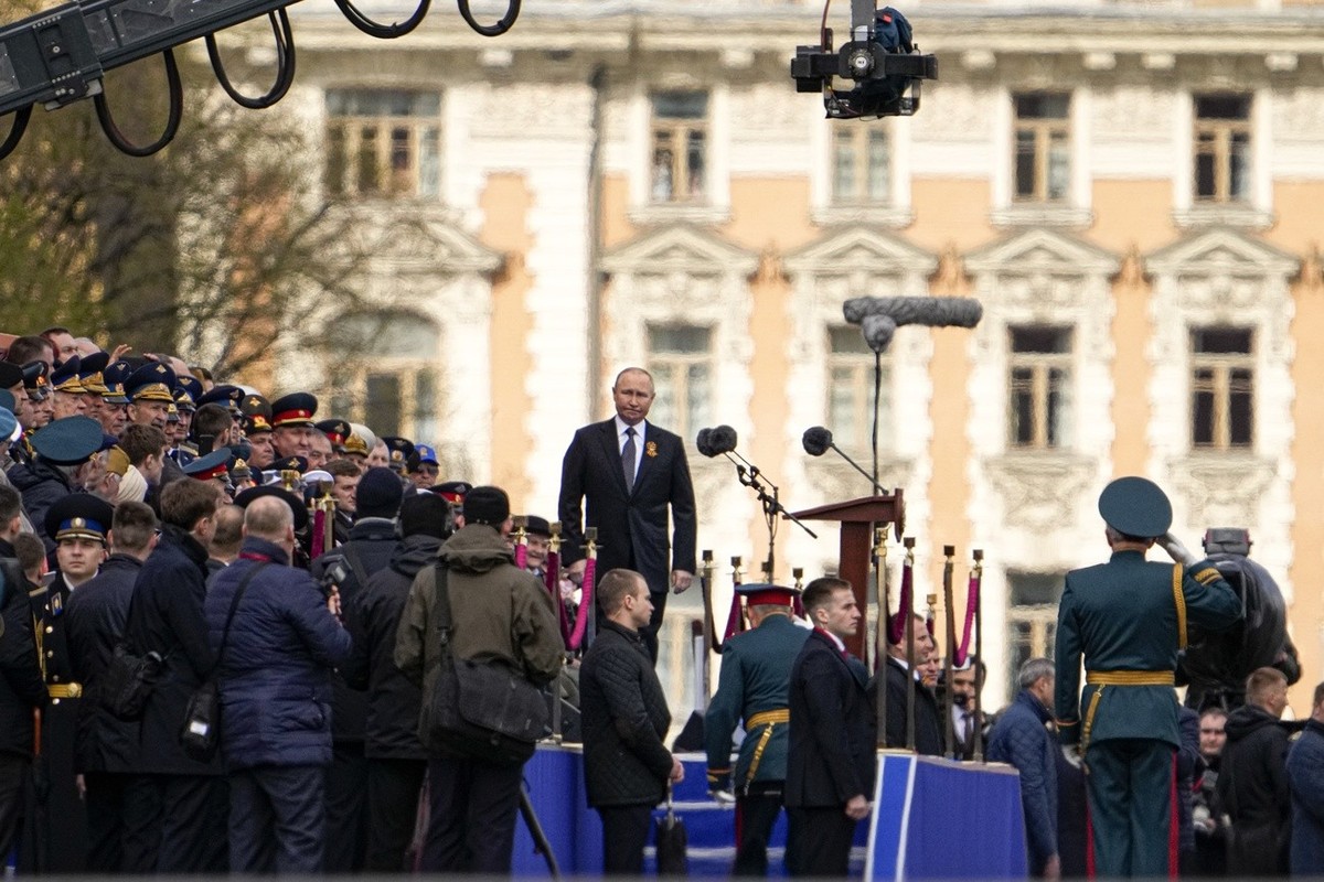 Russian Defense Minister Sergei Shoigu, bottom, arrives to report troops' readiness for the Victory Day parade marking the 77th anniversary of the victory in the World War II to President Vladimi ...