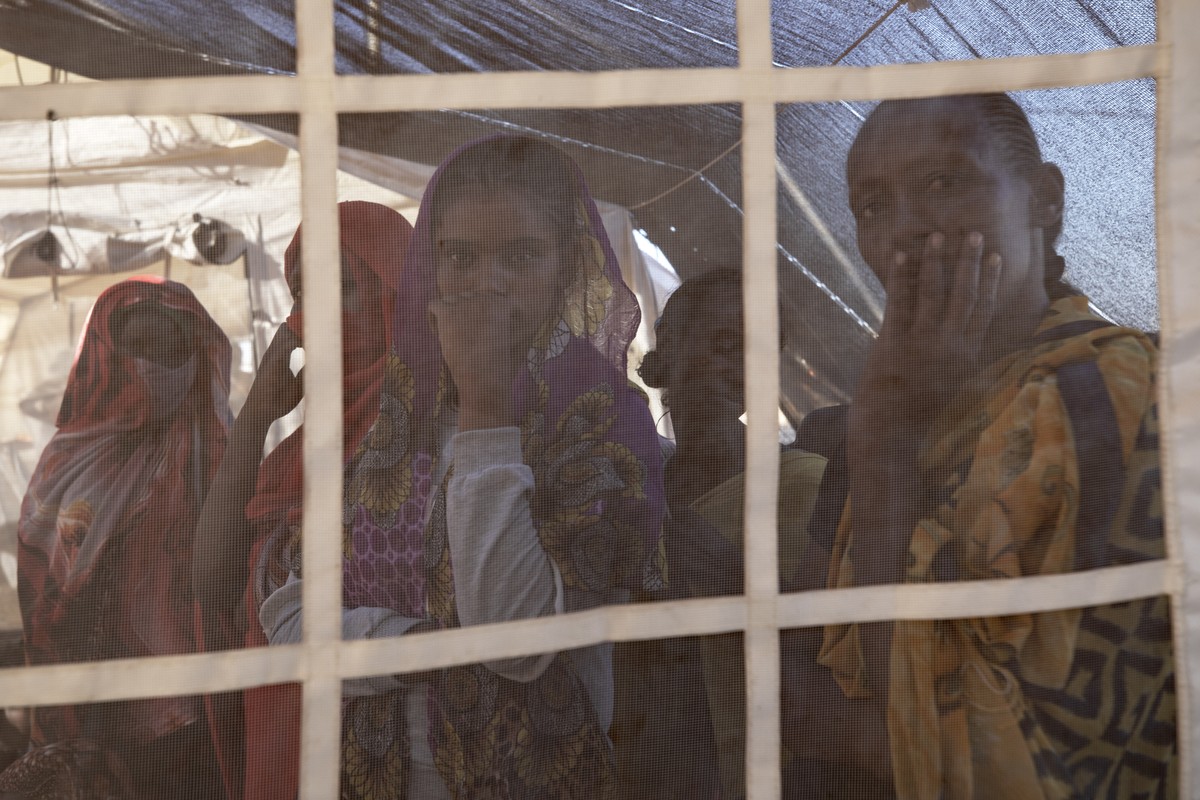 Tigray refugees who fled a conflict in the Ethiopia's Tigray region, wait their turn for treatment at a clinic run by MSF (Doctors Without Borders) in Village 8, the transit center near the Lugdi ...