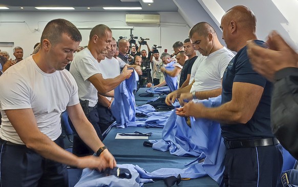 Serb police officers took off their uniforms in the town of Zvecan, Kosovo, Saturday, Nov. 5, 2022. Representatives of the ethnic Serb minority in Kosovo on Saturday resigned from their posts in prote ...