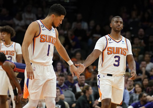 Phoenix Suns&#039; Devin Booker (1) and Chris Paul (3) slap hands during the first half of an NBA preseason basketball game against the Adelaide 36ers, Sunday, Oct. 2, 2022, in Phoenix. (AP Photo/Darr ...