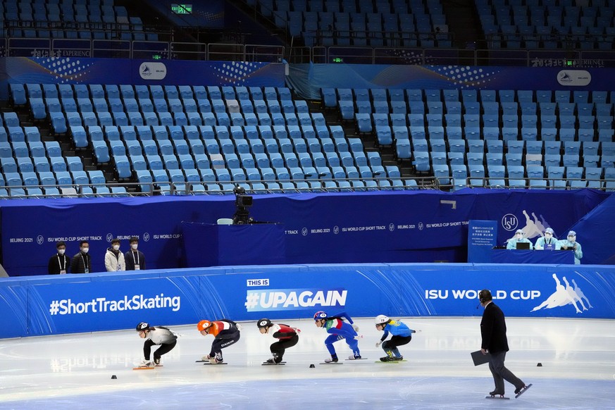 Skaters compete in a heat of the women&#039;s 1000m in front of empty spectator seats at the ISU World Cup Short Track speed skating competition, a test event for the 2022 Winter Olympics, at the Capi ...