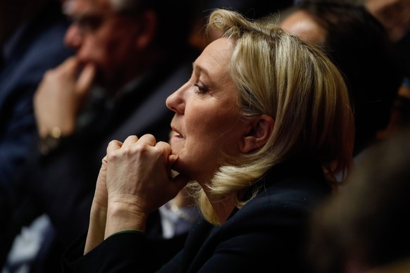 epa10451233 Marine Le Pen of the National Rally listens as the National Assembly begins a debate on the draft law rectifying financing of social security as part of the reform of pensions for 2023, in ...