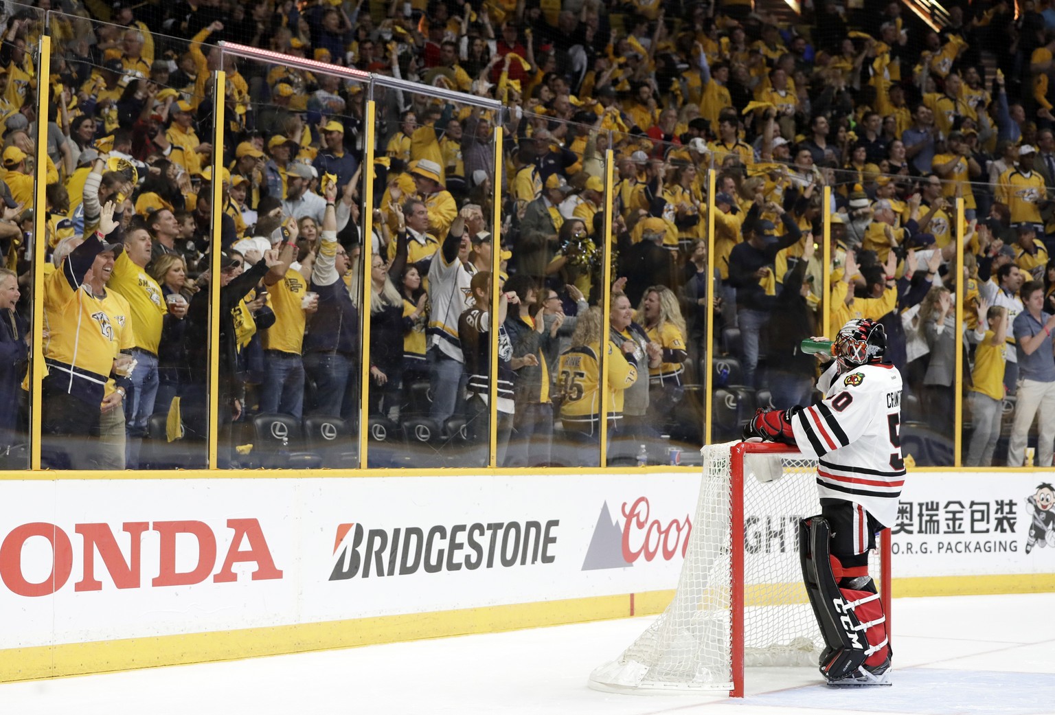 Chicago Blackhawks goalie Corey Crawford (50) takes a drink as Nashville Predators fans cheer after Predators defenseman Roman Josi scored during the second period in Game 4 of a first-round NHL hocke ...