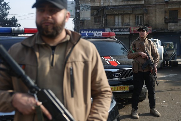 Syrian government forces deploy on the streets as they take over the Achrafieh neighborhood from Kurdish fighters after three days of clashes in a contested area of the northern city of Aleppo, Syria, ...