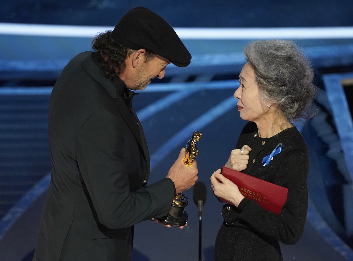 Youn Yuh-jung, right, presents Troy Kotsur with the award for best performance by an actor in a supporting role for "CODA" at the Oscars on Sunday, March 27, 2022, at the Dolby Theatre in Lo ...