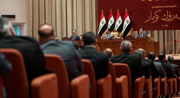 epa10241098 A handout photo made available by Iraqi Parliament Media Office shows Members of Iraqi Parliament attend a session to elect new President of Iraq in Baghdad, Iraq on 13 October 2022. The I ...