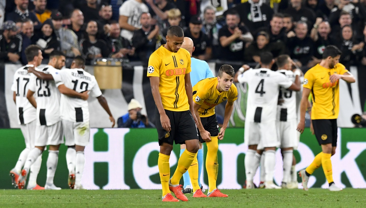 YB&#039;s midfielder Djibril Sow, center left, and YB&#039;s midfielder Sandro Lauper, center right, look desapointed as Juventus&#039; players celebrete the third goal during the UEFA Champions Leagu ...