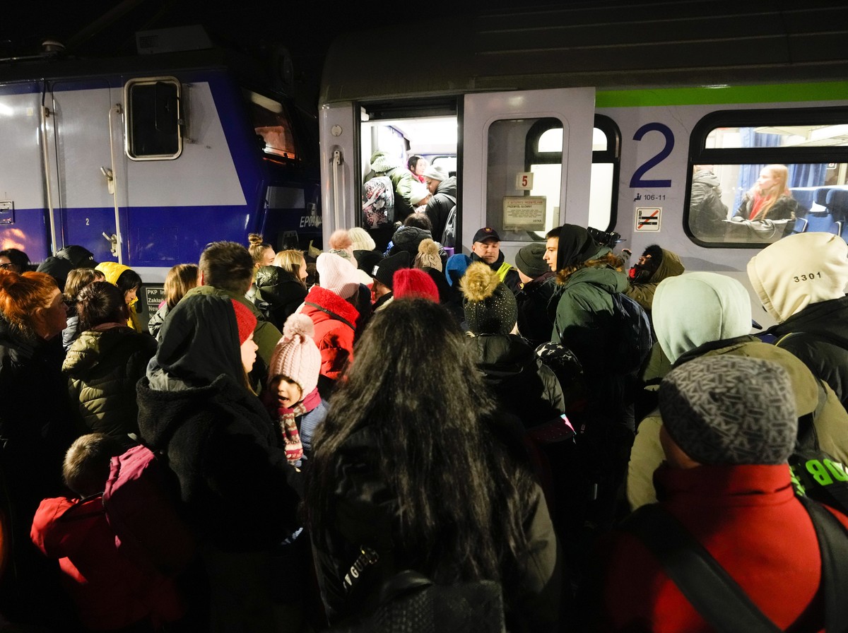 Refugees enter a train after fleeing from the Ukraine at the train station in Przemysl, Poland, Tuesday, March 1, 2022. (AP Photo/Markus Schreiber)
