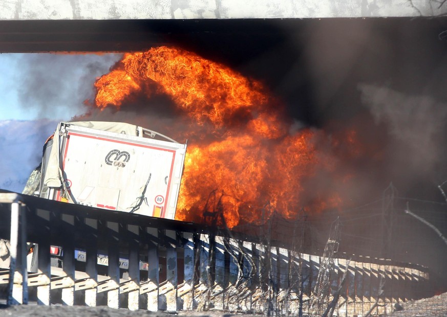 epa06413734 A general view of the wreckage in flames after two children and four adults were killed in a tanker-truck fire on the A21 motorway between Brescia and Turin, Italy, 02 January 2018. The ta ...