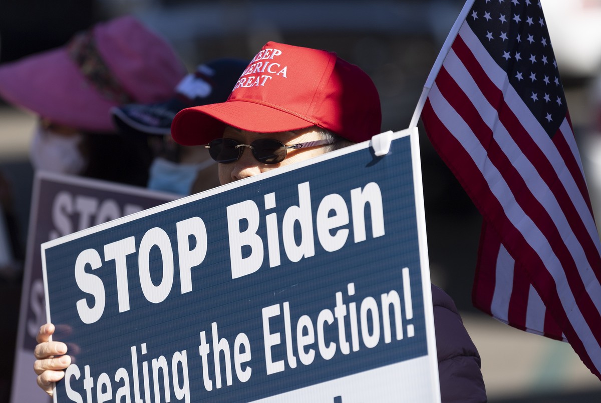 A woman participates in a pro-Trump election integrity rally at the Orange County Registrar of Voters offices in Santa Ana, Calif., Monday, Nov. 9, 2020. The rally was calling attention to what organi ...