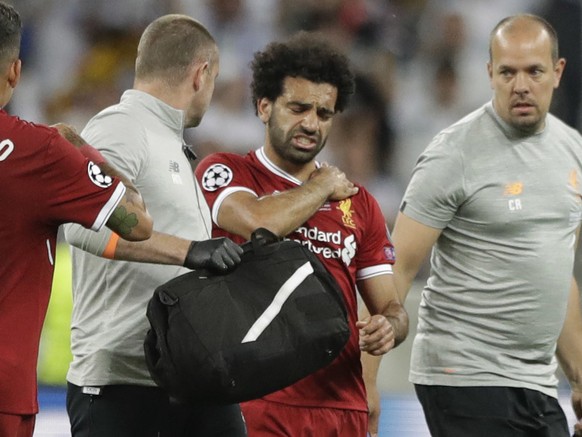 Liverpool&#039;s Mohamed Salah grimaces as he leaves after injuring himself during the Champions League Final soccer match between Real Madrid and Liverpool at the Olimpiyskiy Stadium in Kiev, Ukraine ...