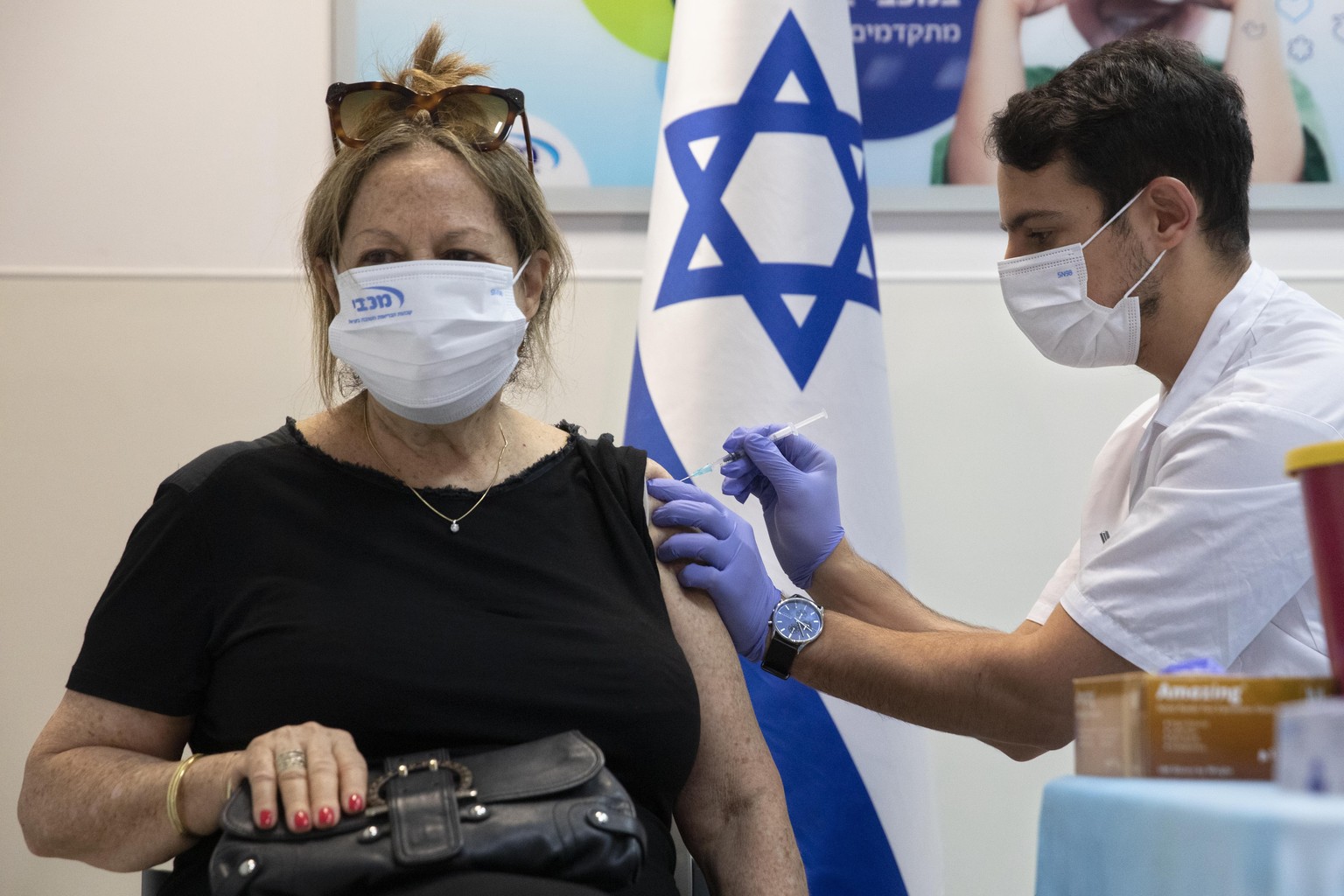 An Israeli woman receives a third Pfizer-BioNTech COVID-19 vaccine in the Israeli city of Ramat HaSharon, Friday, July 30, 2021. Israel&#039;s prime minister on Thursday announced that the country wou ...